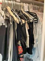 Garments hanging on closet rod showing variety of colors and styles