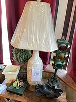 Novelty traffic-light lamp beside other items, showing full height, planter base and topiary