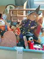 Overall view of assorted seasonal decor items inside bin