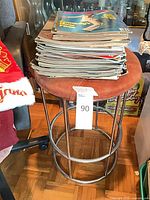 Stool with stack of magazines full view
