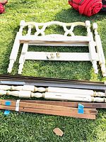 Full view of headboard, side rails, and slats laid on grass