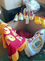 Overall lot view with jersey, white shirt, sneakers, clogs