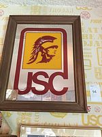 Full view of framed USC Trojans mirror showing logo, frame, overall condition