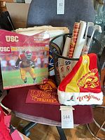 Full lot on chair: calendar, Santa hat, rolled posters, decal sheets, USC mat