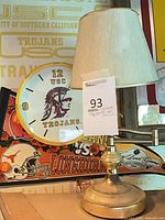 Clock, lamp, pennant grouped on shelf
