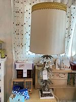 Full view of lamp with shade, surrounding objects for scale