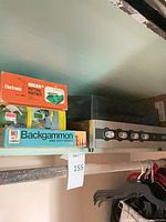 Shelf with Oscar Jr Putting Partner box, Backgammon box, CRC audio component under dust cover