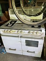 Front view of entire gas range showing burners, knobs and dual oven doors