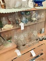 Cabinet view showing mixed stemware and decanters