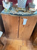 Front view of cabinet showing oak veneer grain and double doors