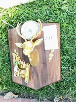 Full view of wood plaque with deer head, clock and hooks