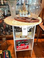 Front angled view of white accent table showing top, shelves and finish