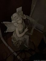 resin fairy statue beside table