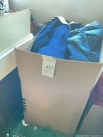 Box containing assorted blue clothing items