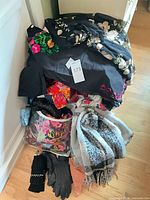 Pile of assorted women’s garments, scarves, gloves