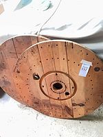 Both wooden spool discs leaning together showing overall size and wear