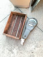 Top view of both items: crate and parking meter head side by side