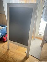 Front view of white-washed A-frame chalkboard sign