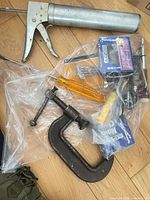 Overview of entire lot with grease gun, clamp, screwdrivers, hardware bag, box