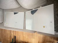 Both mirrors on couch, protective film visible