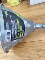 Funnel side showing label with capacity and brand, visible paint residue