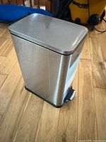 Garbage can closed showing stainless exterior and foot pedal