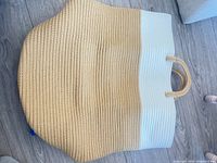 Basket laid flat showing two-tone exterior and handles