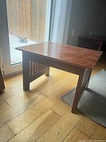 End table side view showing slatted panel and overall structure