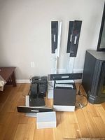Full lot showing towers, satellites, center, subwoofer, receiver, cables