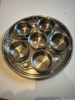 Top view of stainless steel tray with six cups