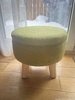 Front view of ottoman showing upholstery and legs