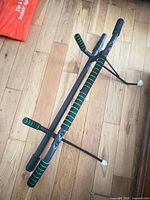 Pull-up bar disassembled showing foam grips and telescoping sections