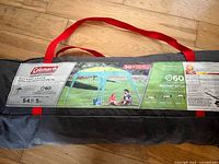 Carry bag with Coleman label showing product image and specs