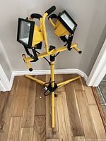 Full view of yellow tripod work light with both halogen heads