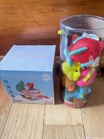 Twefex Baby Tissue Box retail box beside sealed B. toys bath buddies tube