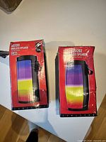 Front view of both unopened speaker boxes displaying models ZQS1201 and ZQS1202