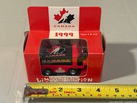 Front view of boxed diecast Zamboni with ruler for scale
