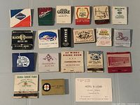 All 19 matchbooks laid out in four rows showing front graphics