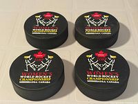 Four pucks displayed top view showing event graphics