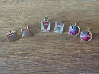 All three pairs of cufflinks laid out side by side