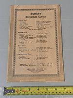 Front or back cover showing title, publisher, taped spine and ruler for scale