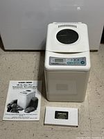 Breadmaker with manual and VHS tape displayed