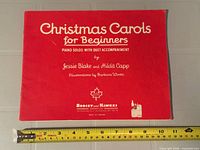 Front cover showing title, authors, publisher and measuring tape for width