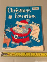 Front cover showing title, publisher logo, measuring tape for size reference