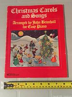 Front cover of sheet music booklet with measuring tape for size reference