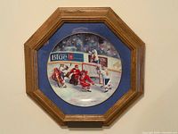 Front view of framed collector plate showing hockey scene