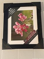 Front view of Studio Decor frame with white mat and product label