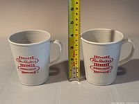 front view of both cups with tape measure