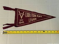 Full pennant beside tape measure showing length