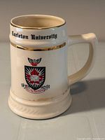 Front view showing crest, gold rim band, handle